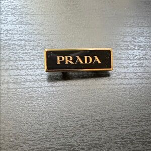 Prada Black and Gold pin